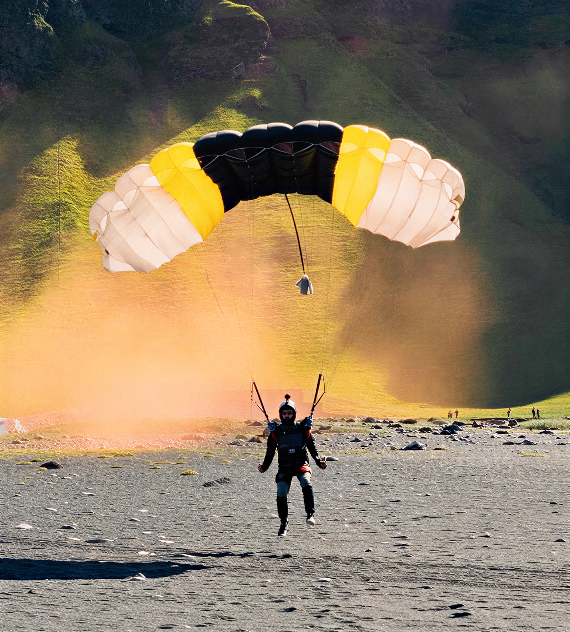 Skydivers celebrating on the grass after landing at the Jump Iceland dropzone